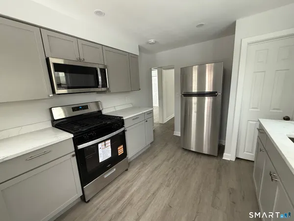 a kitchen with stainless steel appliances a stove microwave and a refrigerator