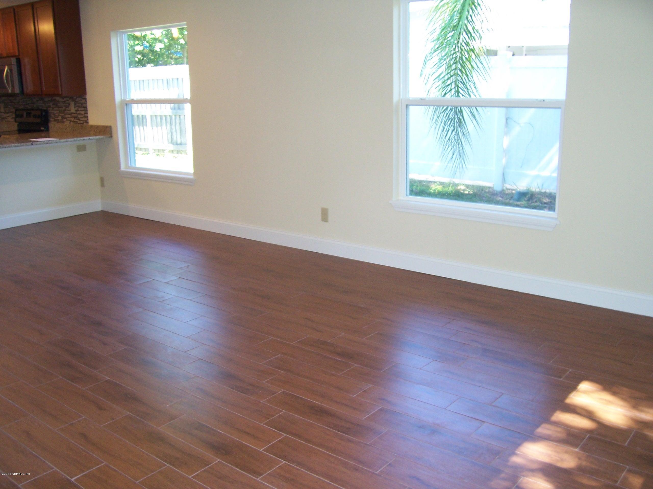 777 Vecuna Road Atlantic Beach, FL 32233 - Photo 5 of 25 an empty room with wooden floor and windows