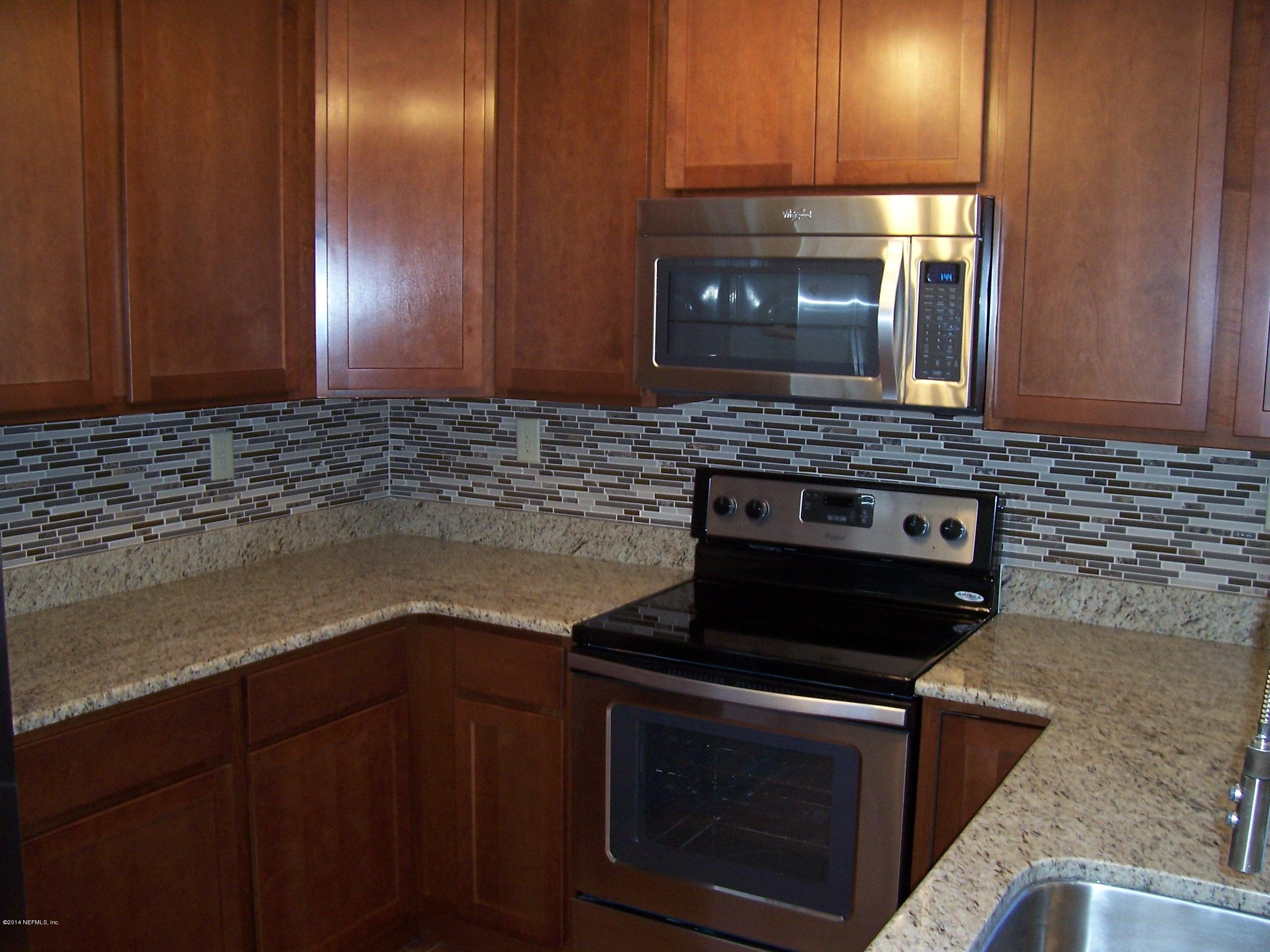 777 Vecuna Road Atlantic Beach, FL 32233 - Photo 9 of 25 a stove top oven sitting inside of a kitchen