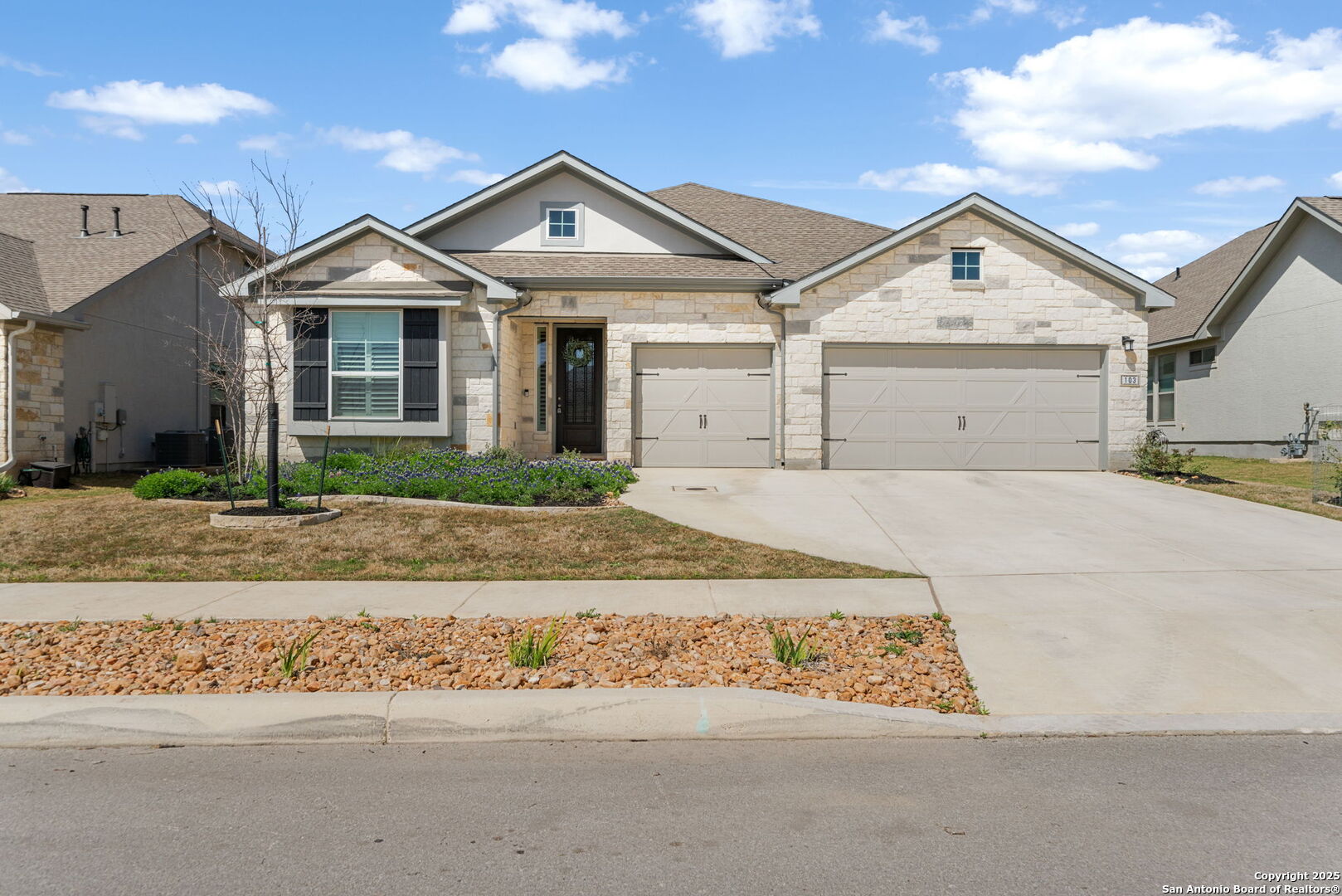 a view of a white house with a street