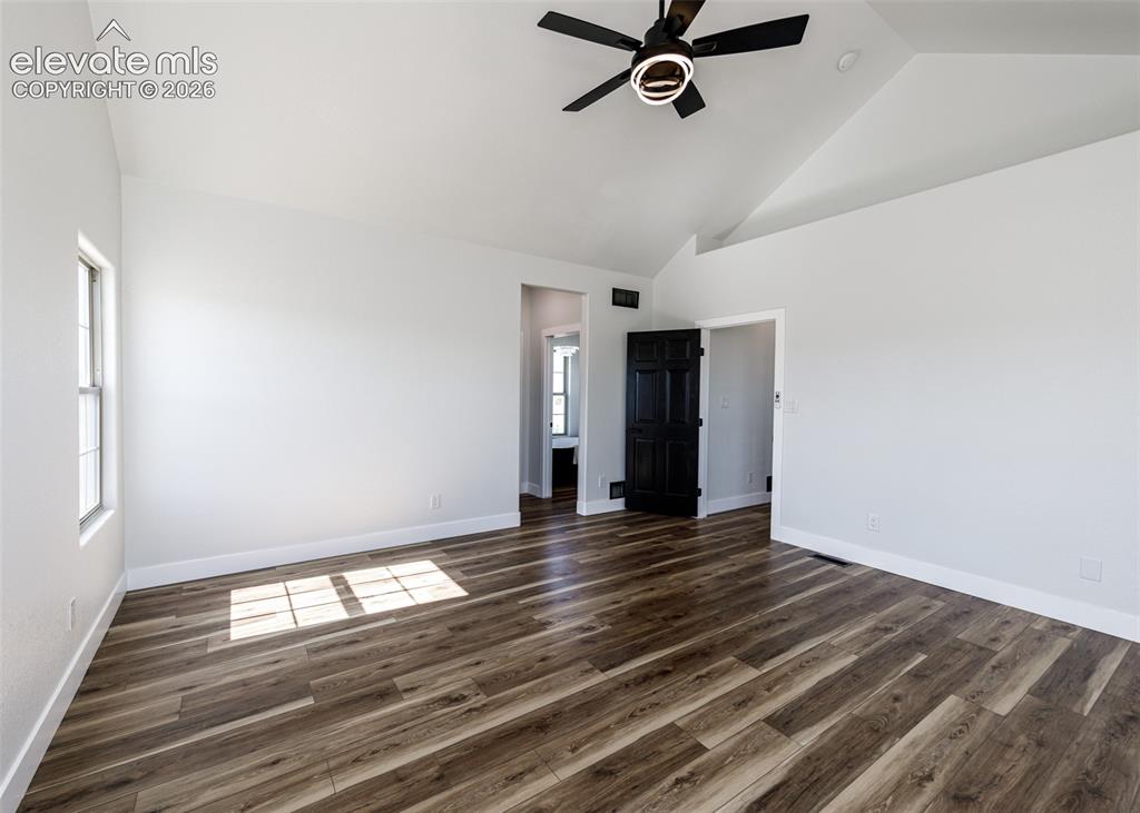 1120 Newton Road Pueblo, CO 81005 - Photo 13 of 46 a view of an empty room with wooden floor and a window