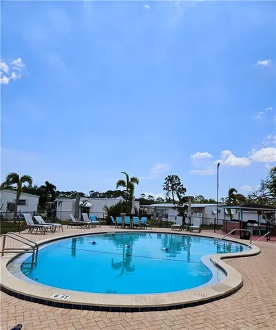 a view of a swimming pool with a table and chairs