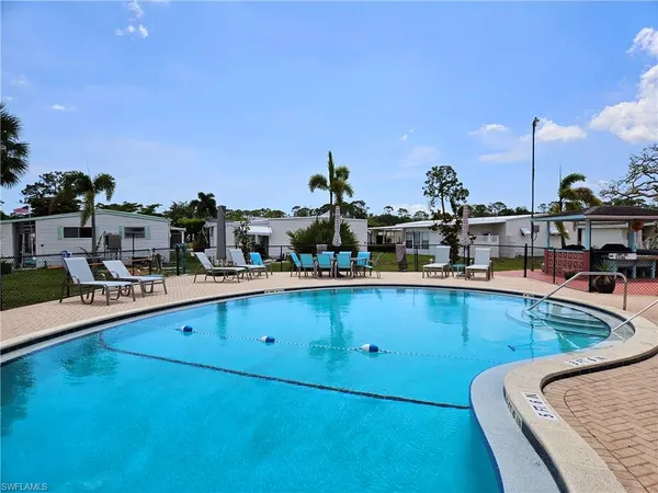 a view of a swimming pool and an outdoor seating