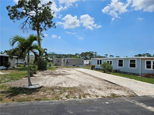 a front view of a house with a yard tree and a yard