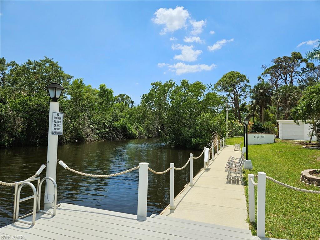 71 Sturbridge Lane Fort Myers, FL 33908 - Photo 6 of 14 a wooden deck with a lake view