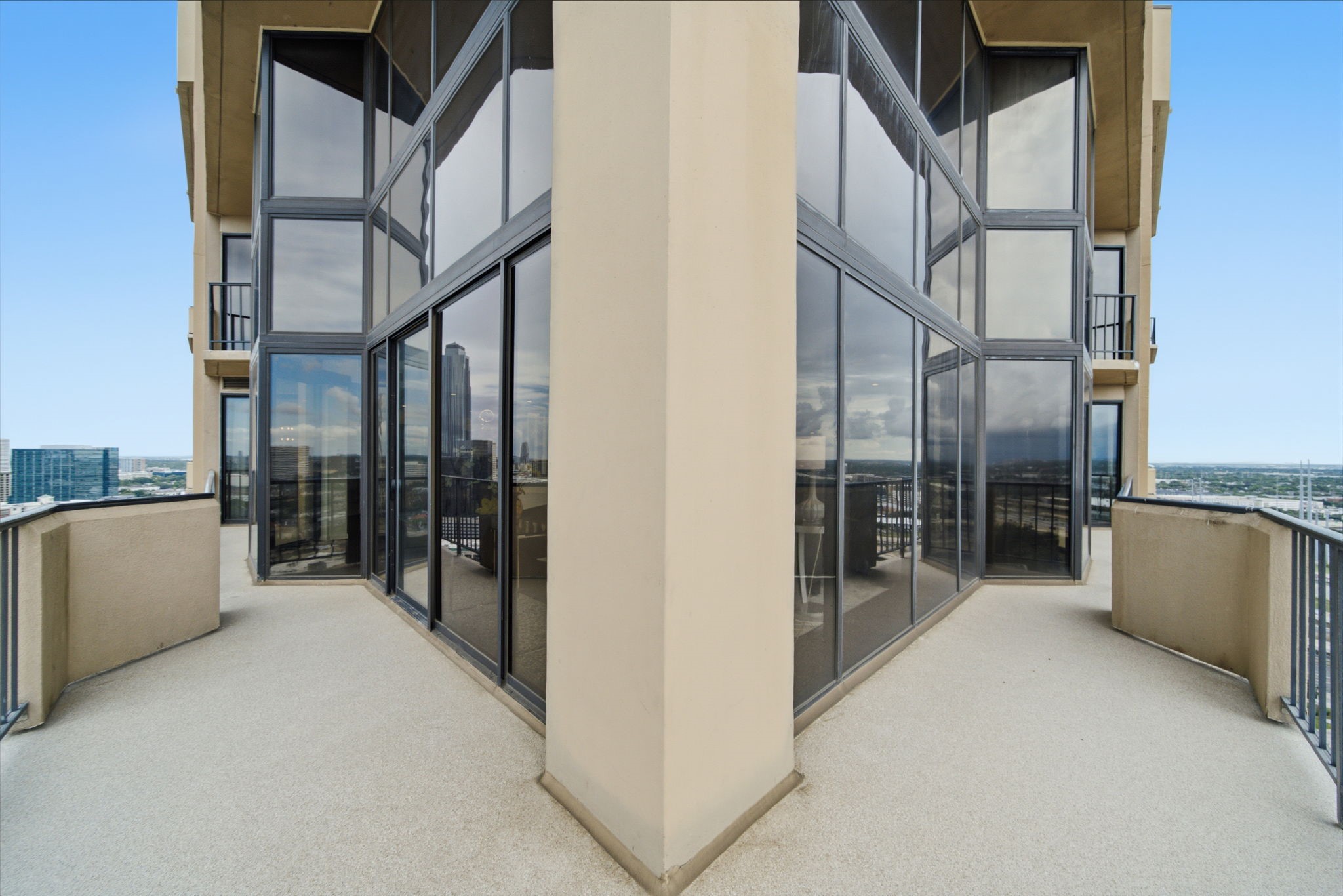 3350 McCue Road, Unit 2402 Houston, TX 77056 - Photo 40 of 49 Dramatic wrap-around glass walls and bold architectural angles frame this expansive outdoor terrace, highlighting panoramic views of the Galleria skyline. Secure perimeter railings and smooth decking provide the ultimate elevated setting for open-air lounging above the city.