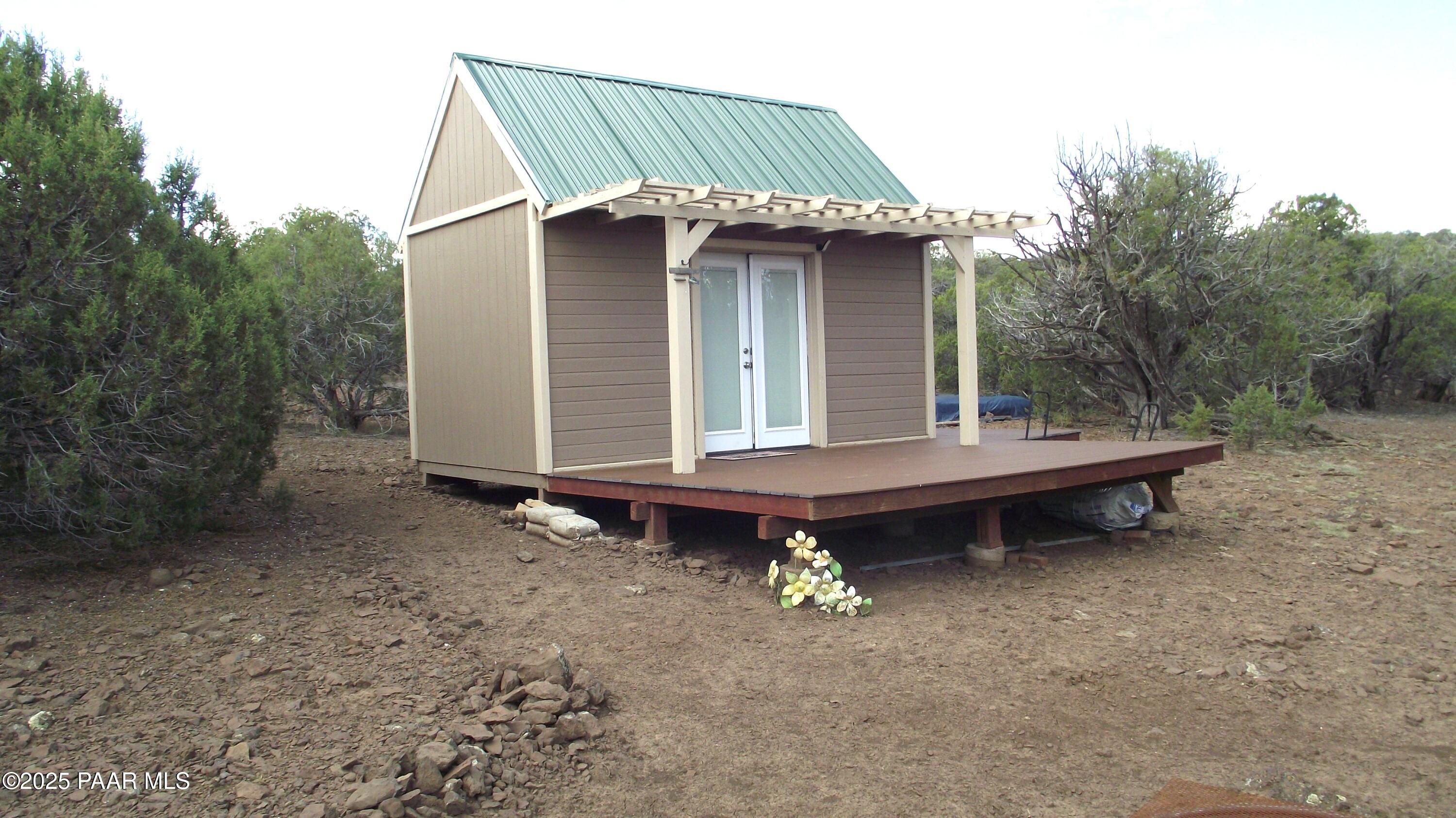 Lot 13 Westwood Ranch Williams, AZ 86046 - Photo 3 of 34 a backyard of a house with wooden deck table and chairs