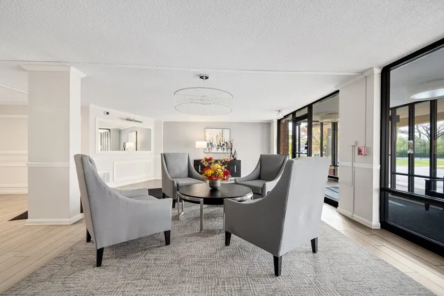 a living room with furniture a desk and chair with wooden floor