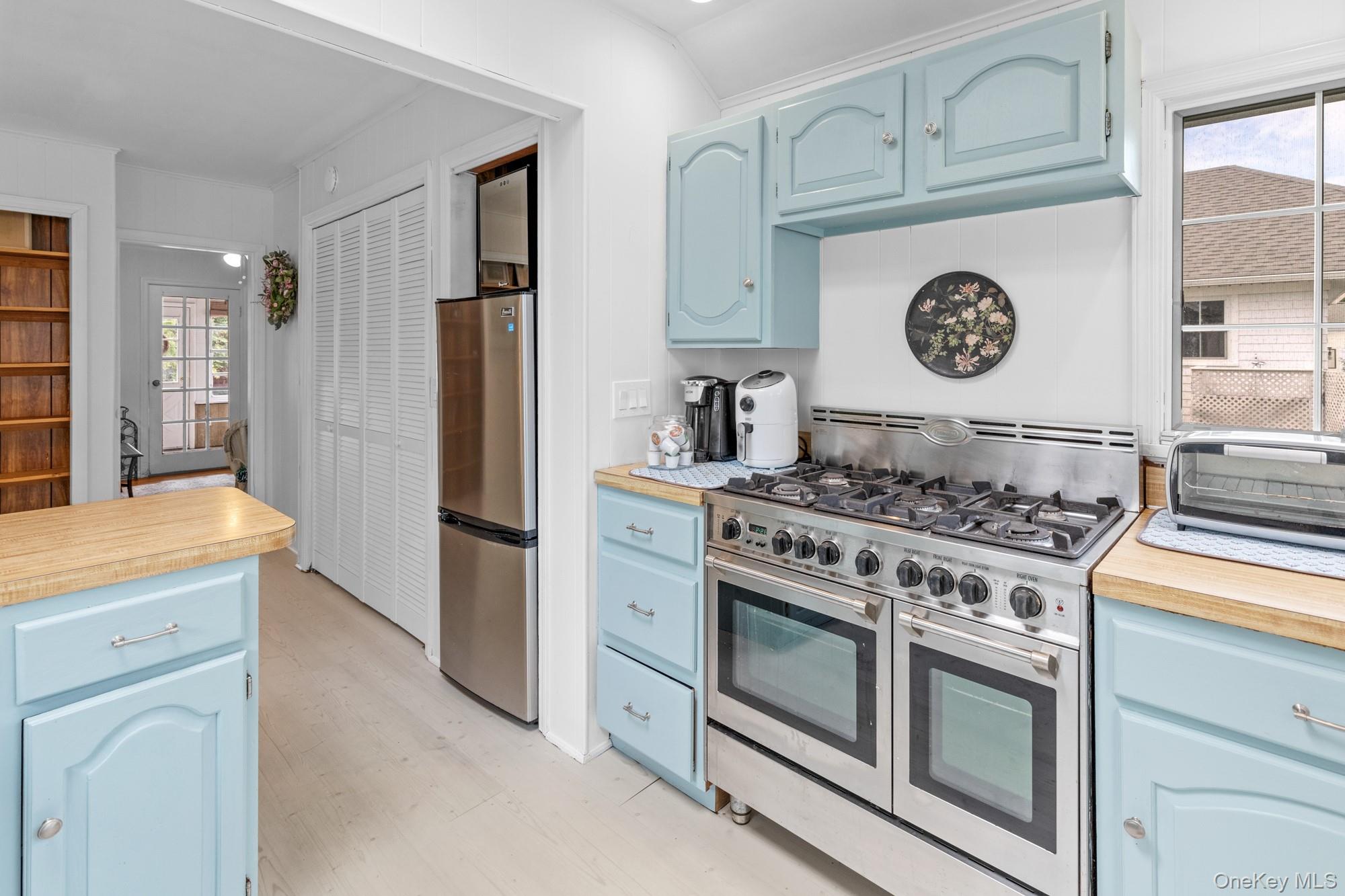 64 Point Street South Jamesport, NY 11970 - Photo 13 of 29 a kitchen with a stove and a refrigerator