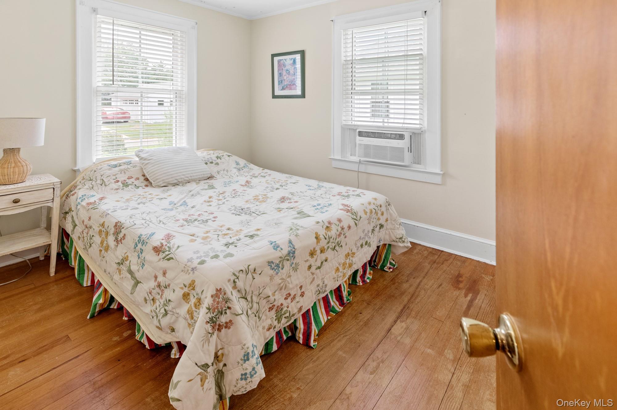 64 Point Street South Jamesport, NY 11970 - Photo 15 of 29 a bed sitting in a bedroom next to a window