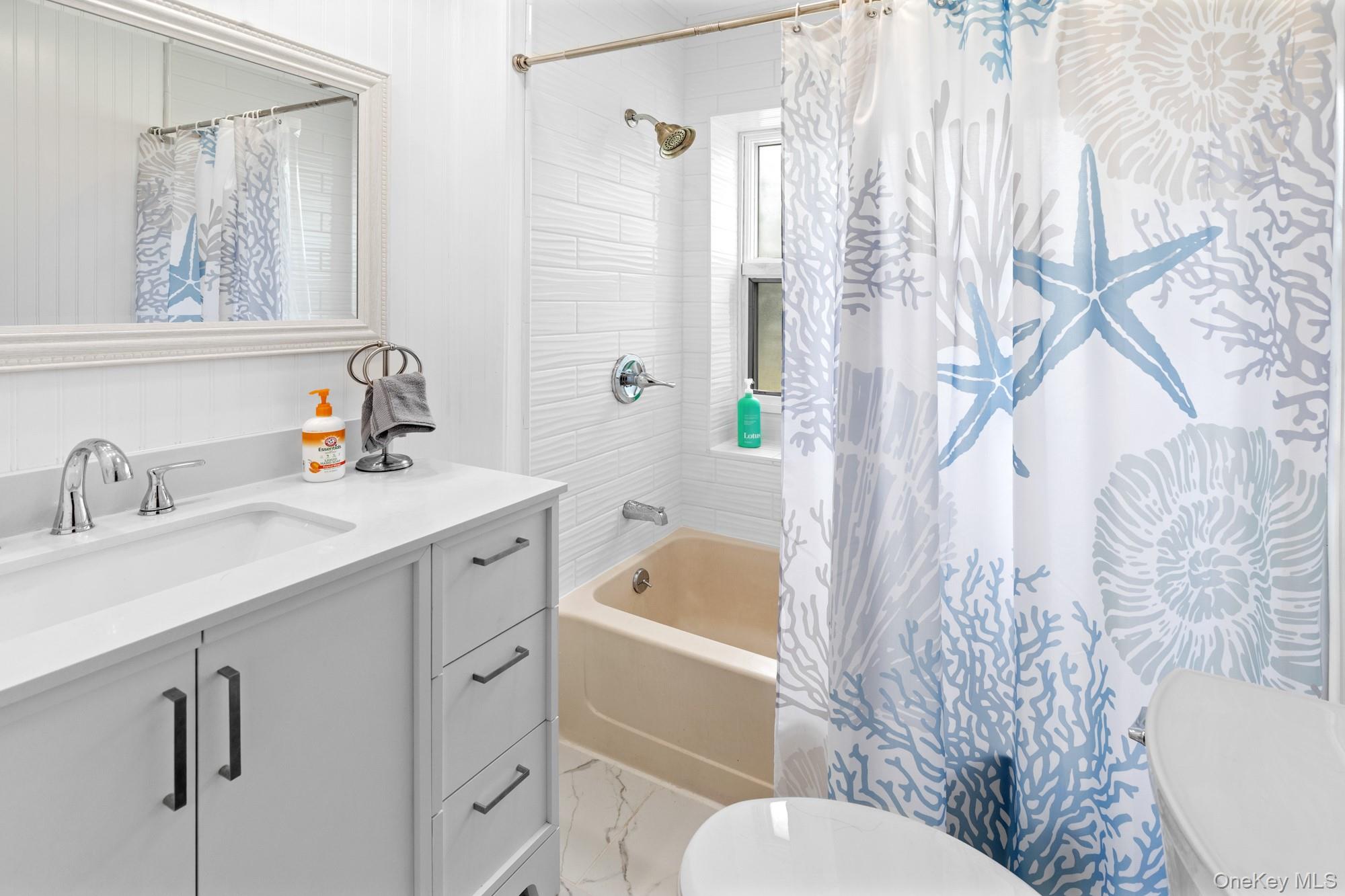 64 Point Street South Jamesport, NY 11970 - Photo 16 of 29 a bathroom with a sink toilet and shower