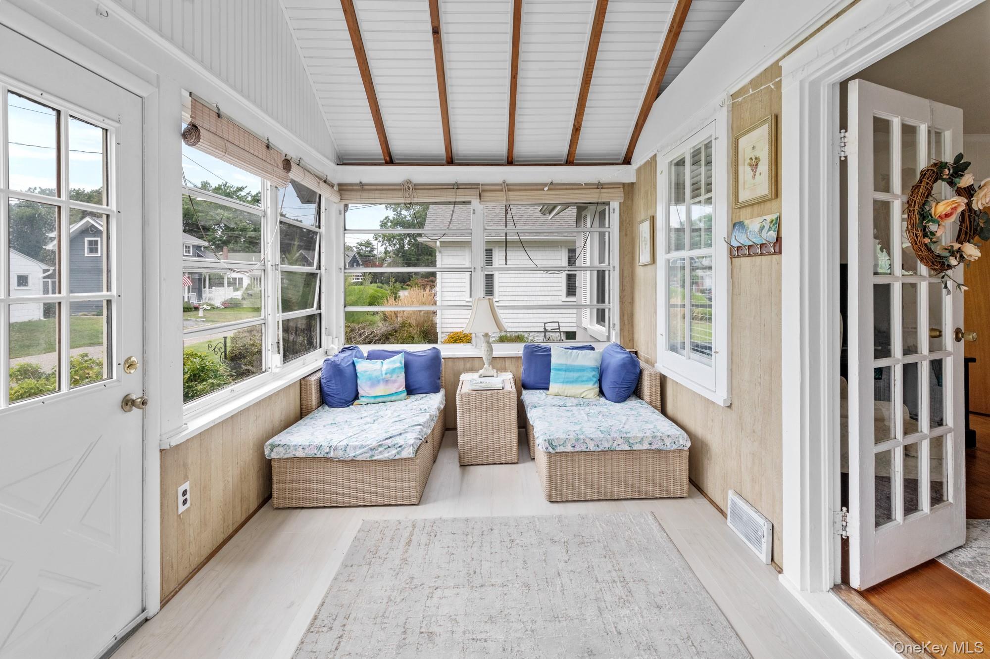 64 Point Street South Jamesport, NY 11970 - Photo 6 of 29 a living room with furniture and a large window