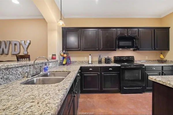 a kitchen with a sink stove and cabinets