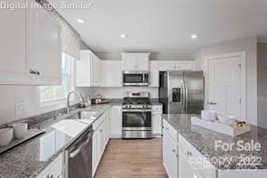 997 Pemberley Street, Unit 3177 Lancaster, SC 29720 - Photo 2 of 12 a kitchen with stainless steel appliances granite countertop a sink stove and refrigerator