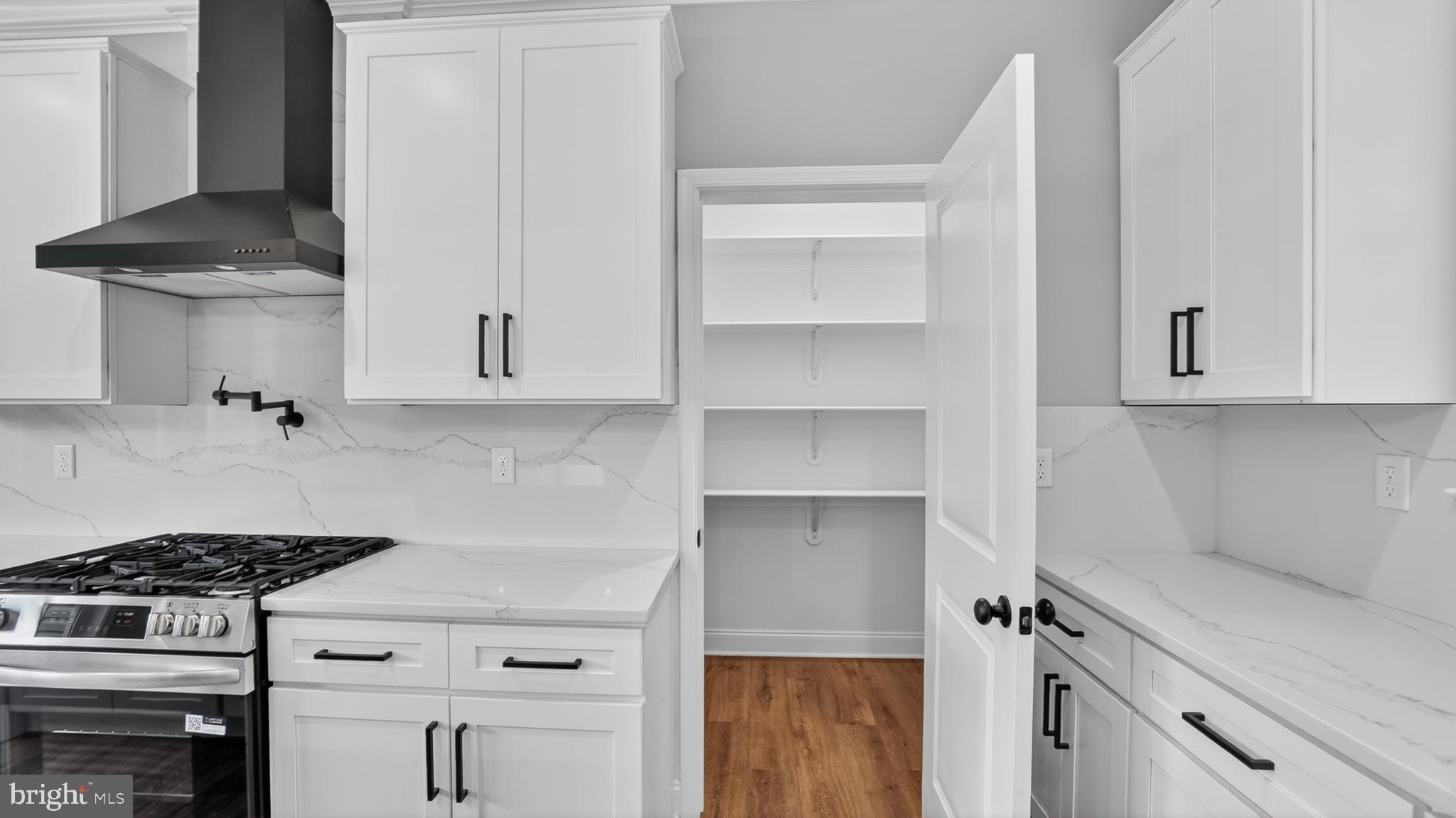 2001 Poplar Ridge Road Pasadena, MD 21122 - Photo 14 of 83 a kitchen with white cabinets and appliances