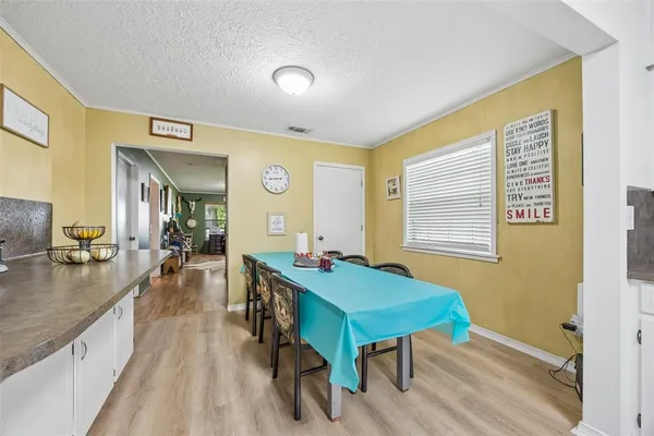 a dining room with wooden floor and a table