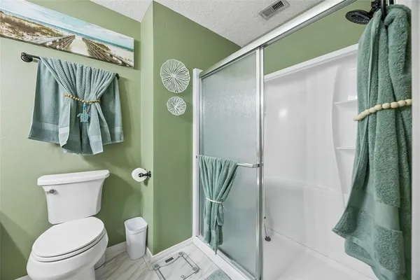 a bathroom with a toilet a sink and shower