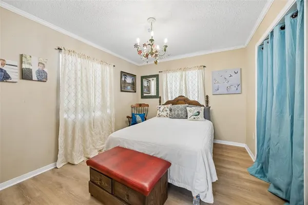 a bedroom with a bed and a chandelier