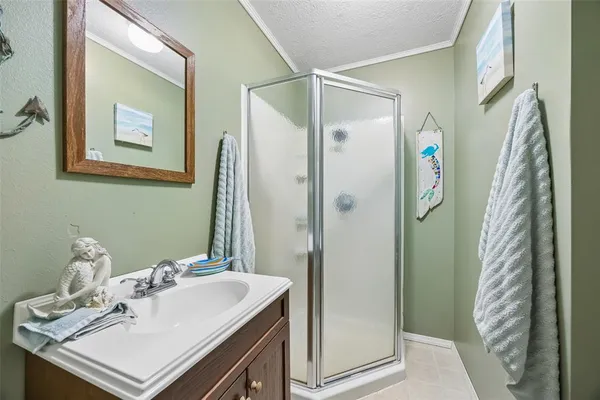 a bathroom with a sink a mirror and a shower