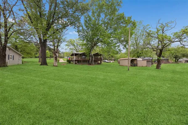 a view of house with a yard