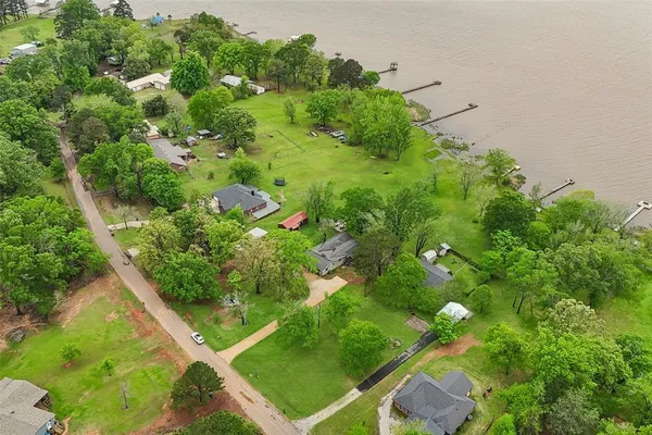 an aerial view of a backyard with table and chairs