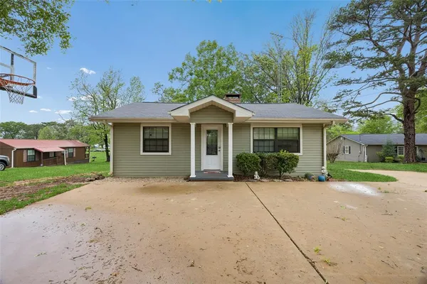a front view of a house with a yard and a garage