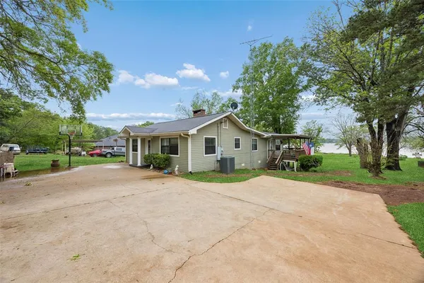 a yellow house with trees in front of it