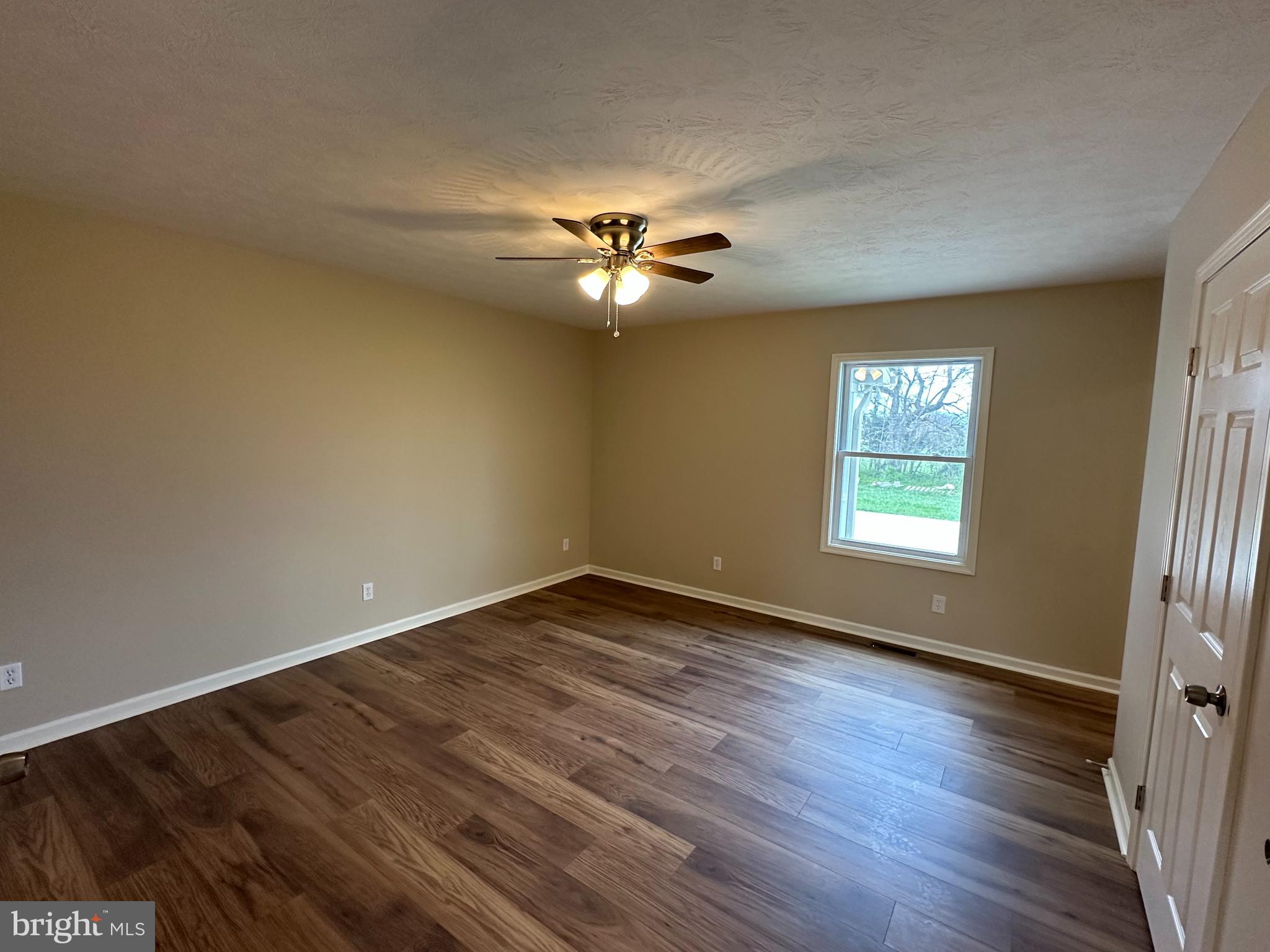 218 Honeyville Road Stanley, VA 22851 - Photo 12 of 27 an empty room with wooden floor and windows