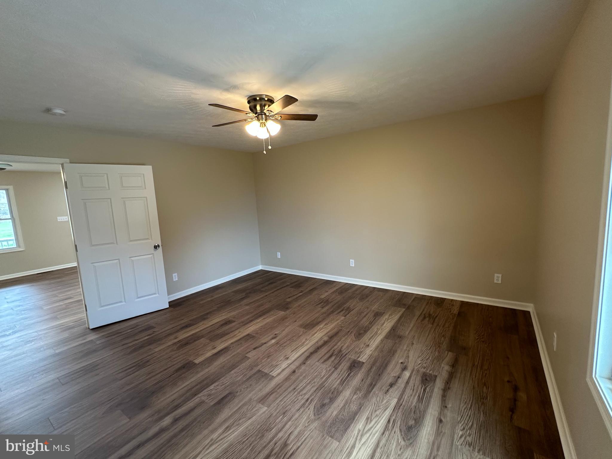 218 Honeyville Road Stanley, VA 22851 - Photo 15 of 27 an empty room with wooden floor and chandelier fan