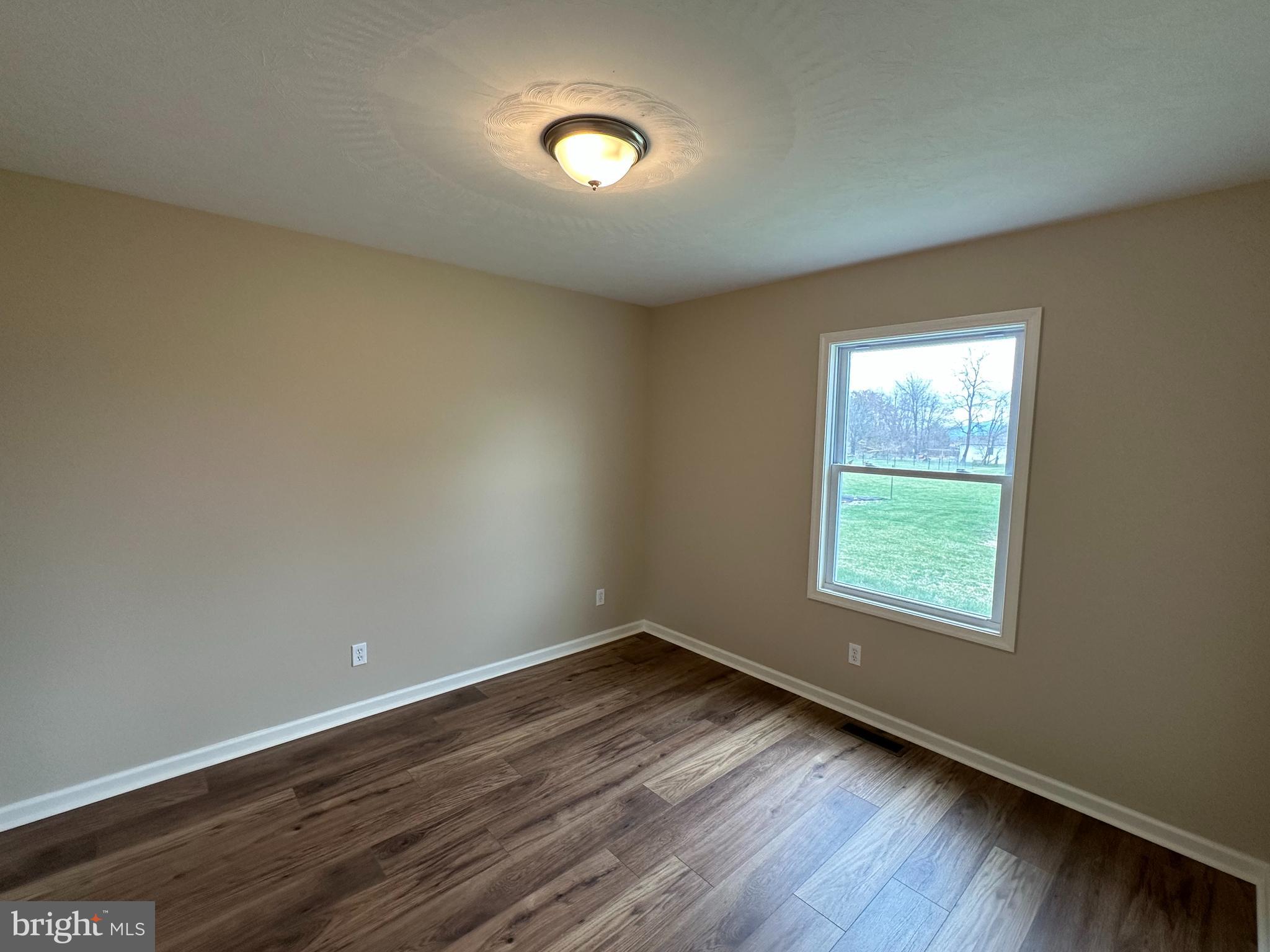 218 Honeyville Road Stanley, VA 22851 - Photo 16 of 27 an empty room with wooden floor and windows