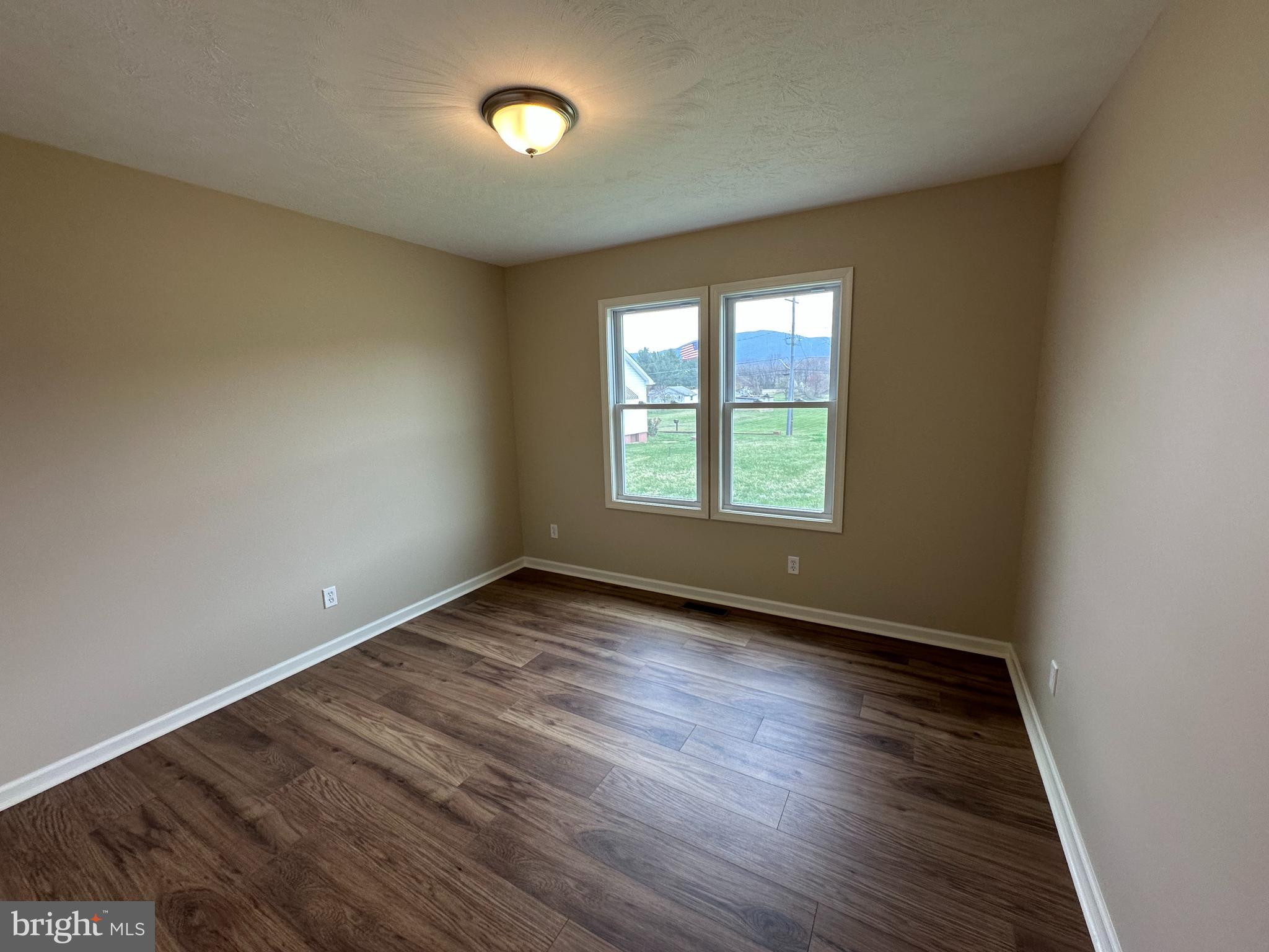 218 Honeyville Road Stanley, VA 22851 - Photo 20 of 27 an empty room with wooden floor and windows