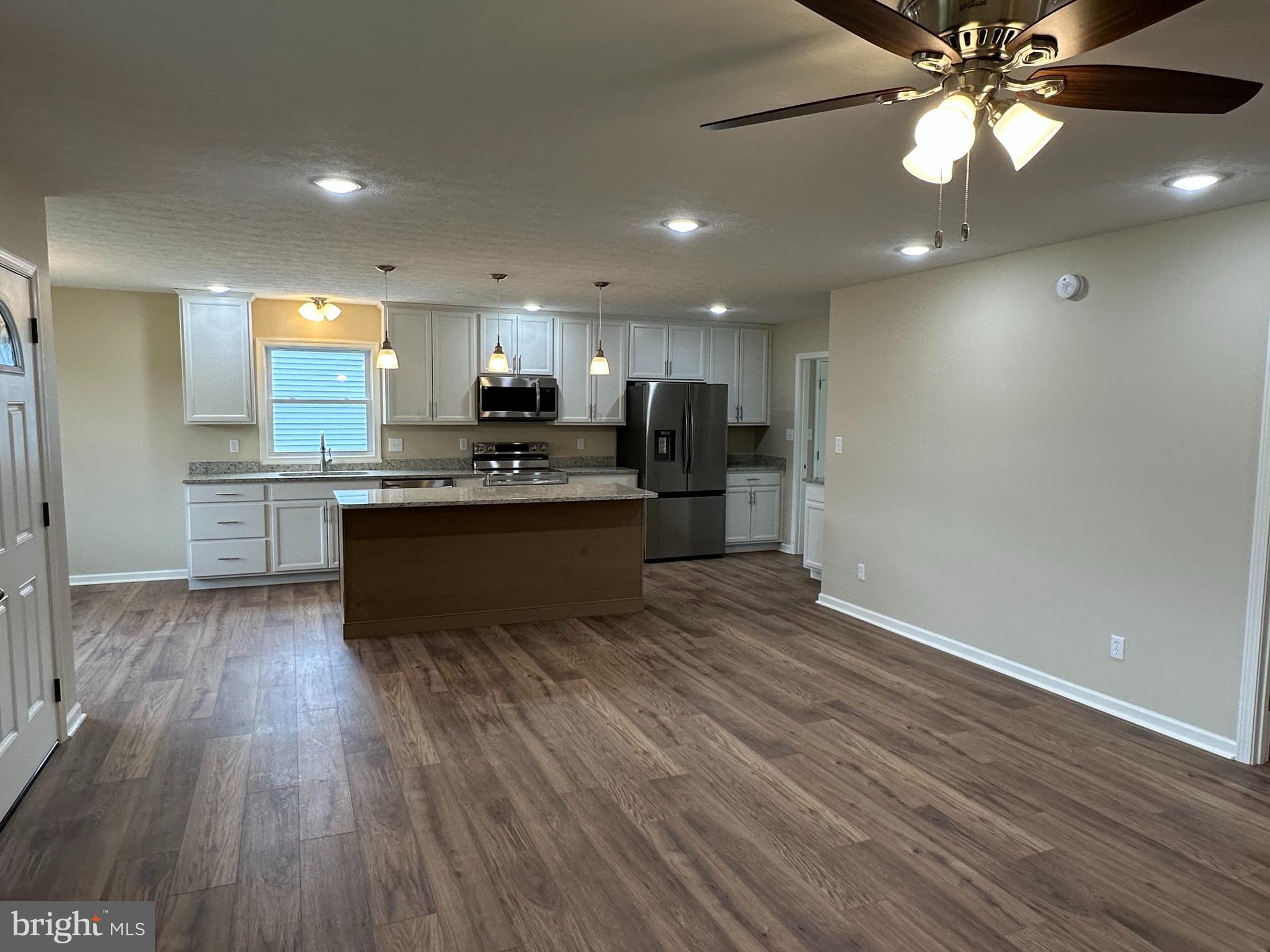 218 Honeyville Road Stanley, VA 22851 - Photo 5 of 27 a kitchen with stainless steel appliances granite countertop a sink cabinets and wooden floor