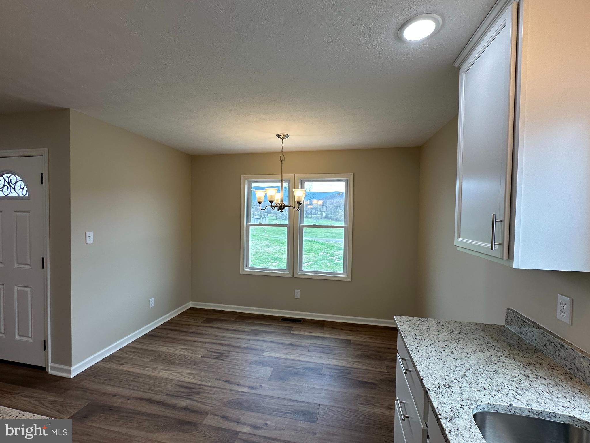 218 Honeyville Road Stanley, VA 22851 - Photo 9 of 27 wooden floor in an empty room with a window