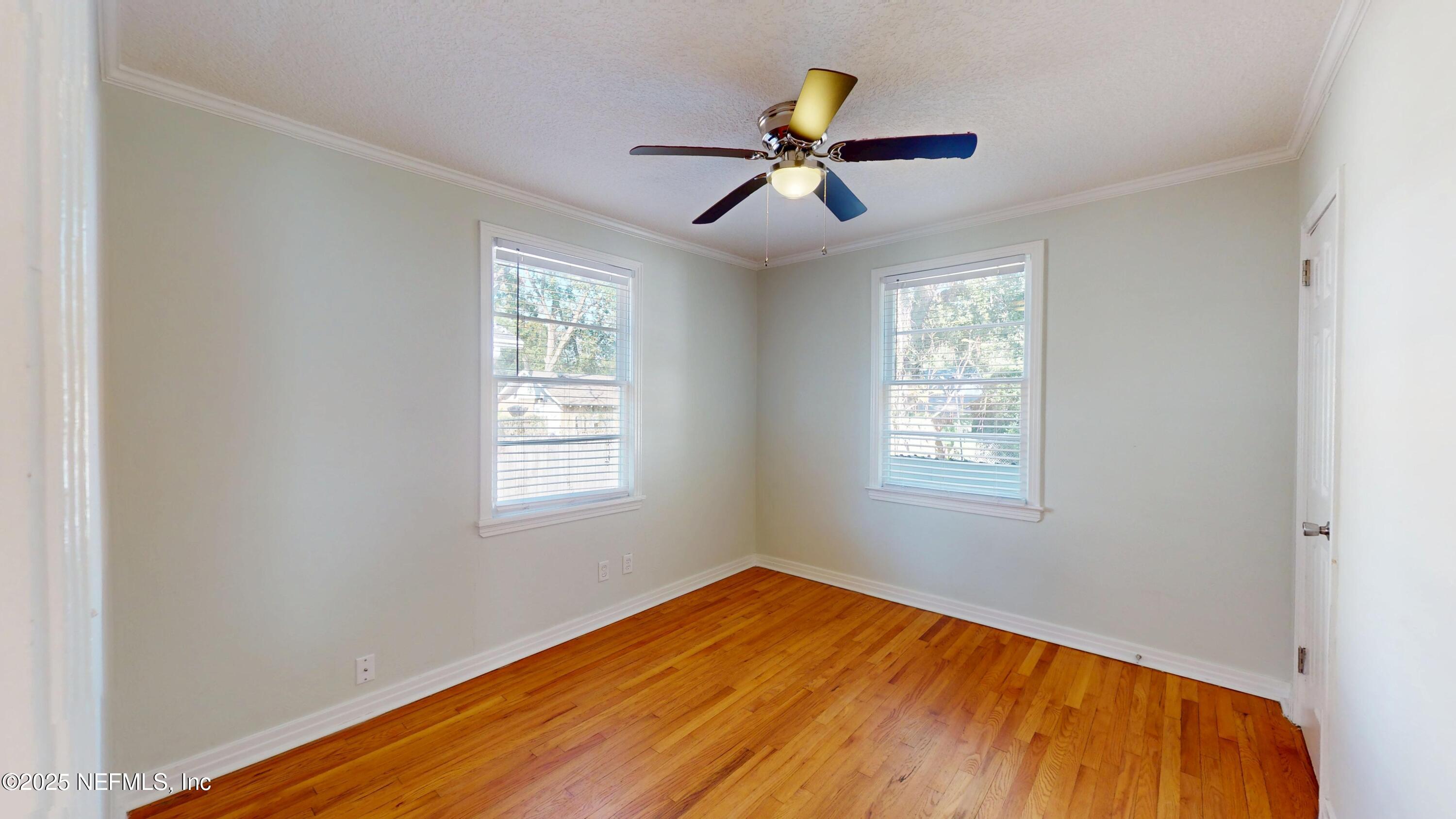 4547 Post Street Jacksonville, FL 32205 - Photo 16 of 23 a view of empty room with wooden floor and fan