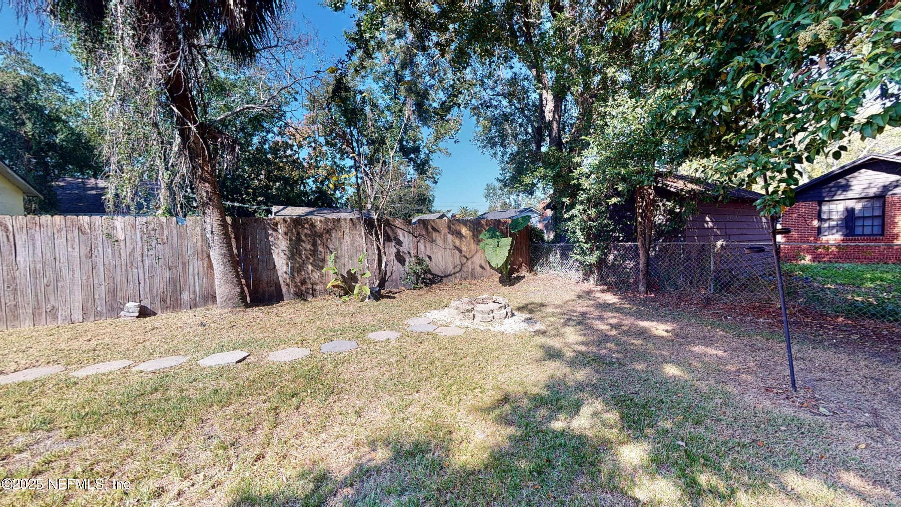4547 Post Street Jacksonville, FL 32205 - Photo 22 of 23 a view of a backyard with large trees and wooden fence