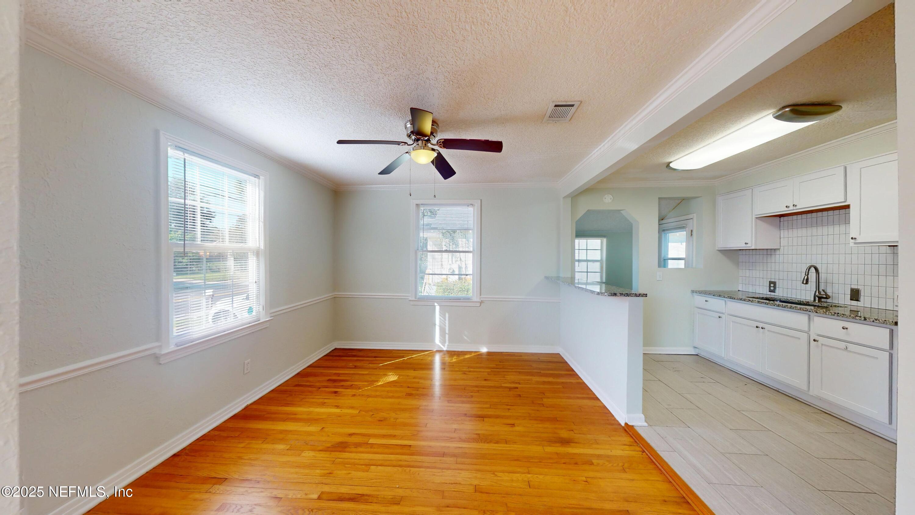 4547 Post Street Jacksonville, FL 32205 - Photo 7 of 23 a very nice looking kitchen with granite countertop a stove a sink dishwasher and a fireplace with wooden floor