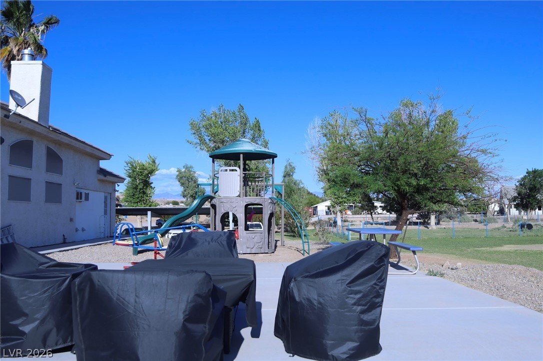 2775 Taylor Street Logandale, NV 89021 - Photo 31 of 41 This spacious yard features a vibrant playground and ample outdoor space, ideal for recreation and relaxation.