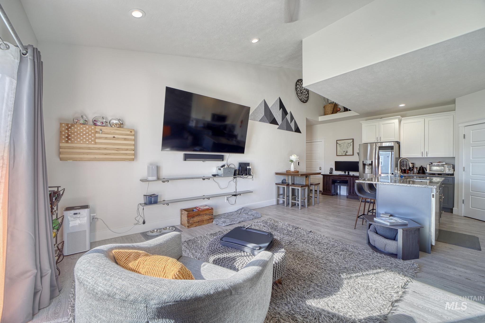 1087 Easy Avenue Twin Falls, ID 83301 - Photo 6 of 25 Living room featuring vaulted ceiling, recessed lighting, and light wood-type flooring