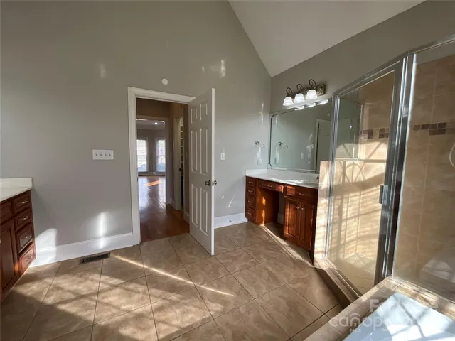 a view of a bathroom with dual sinks