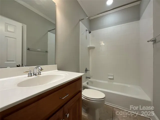 a bathroom with a bathtub shower sink vanity and toilet