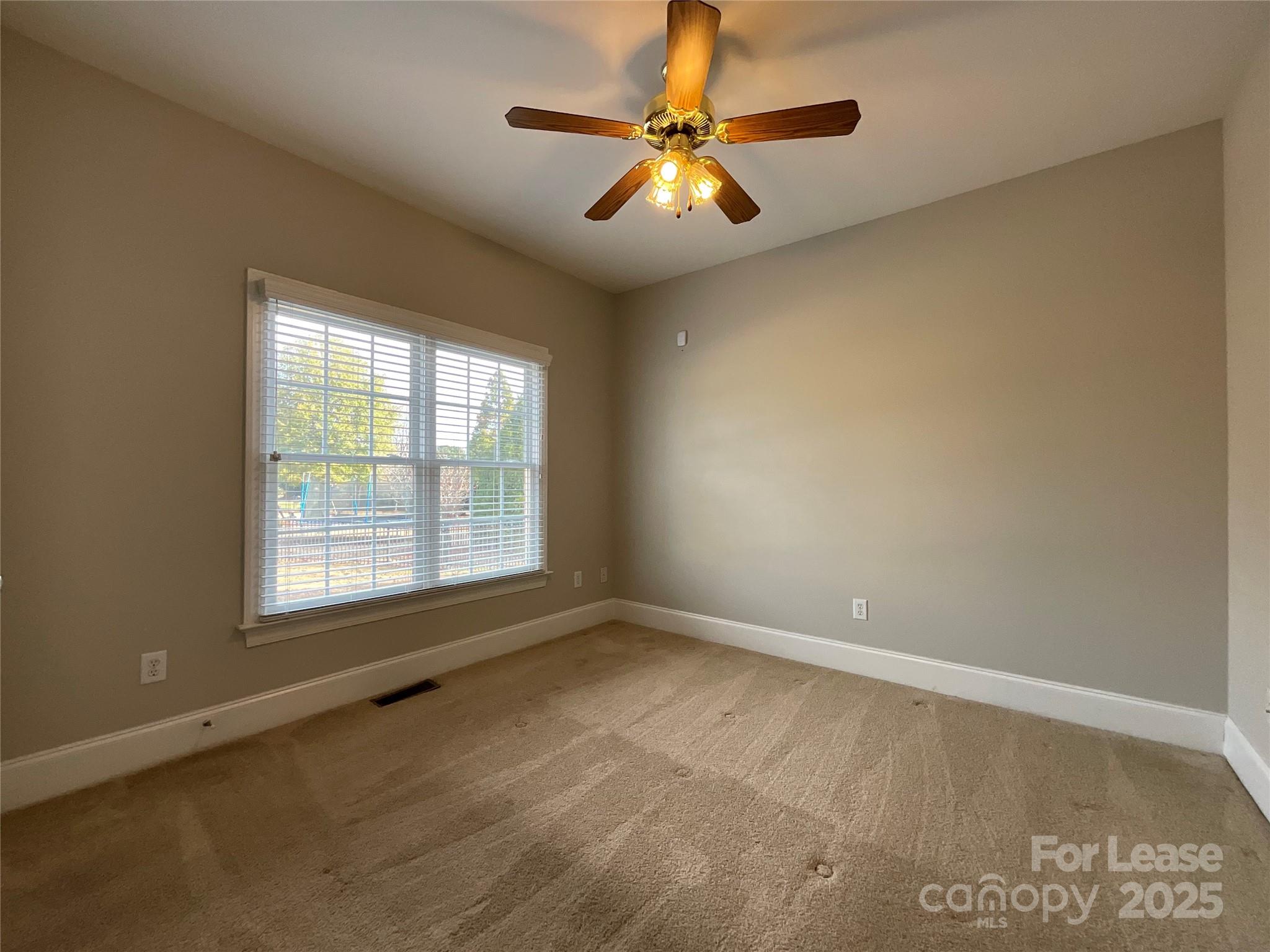 3100 Sea Island Lane Harrisburg, NC 28075 - Photo 17 of 30 an empty room with windows and fan