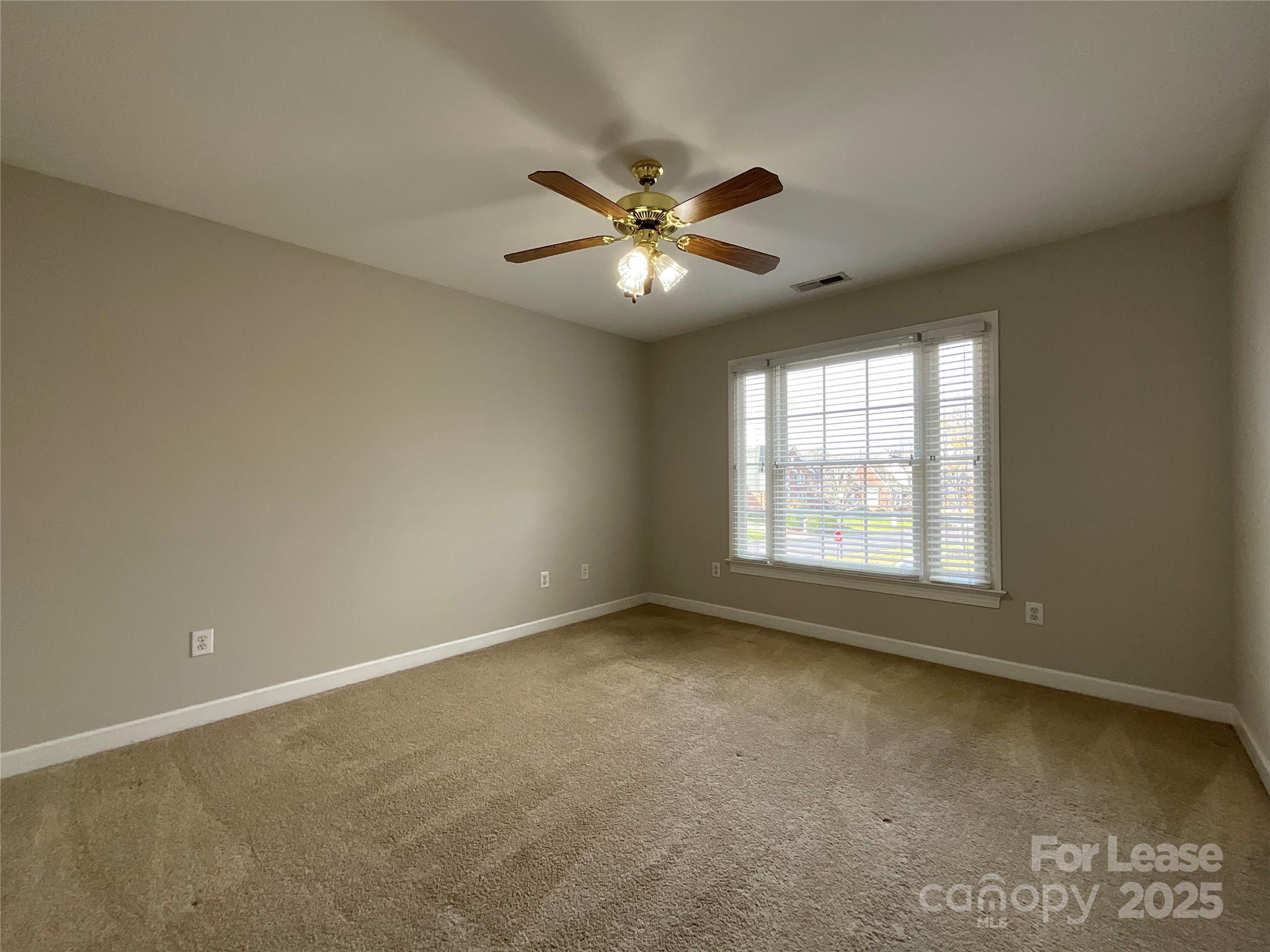 3100 Sea Island Lane Harrisburg, NC 28075 - Photo 19 of 30 an empty room with a window and a fan