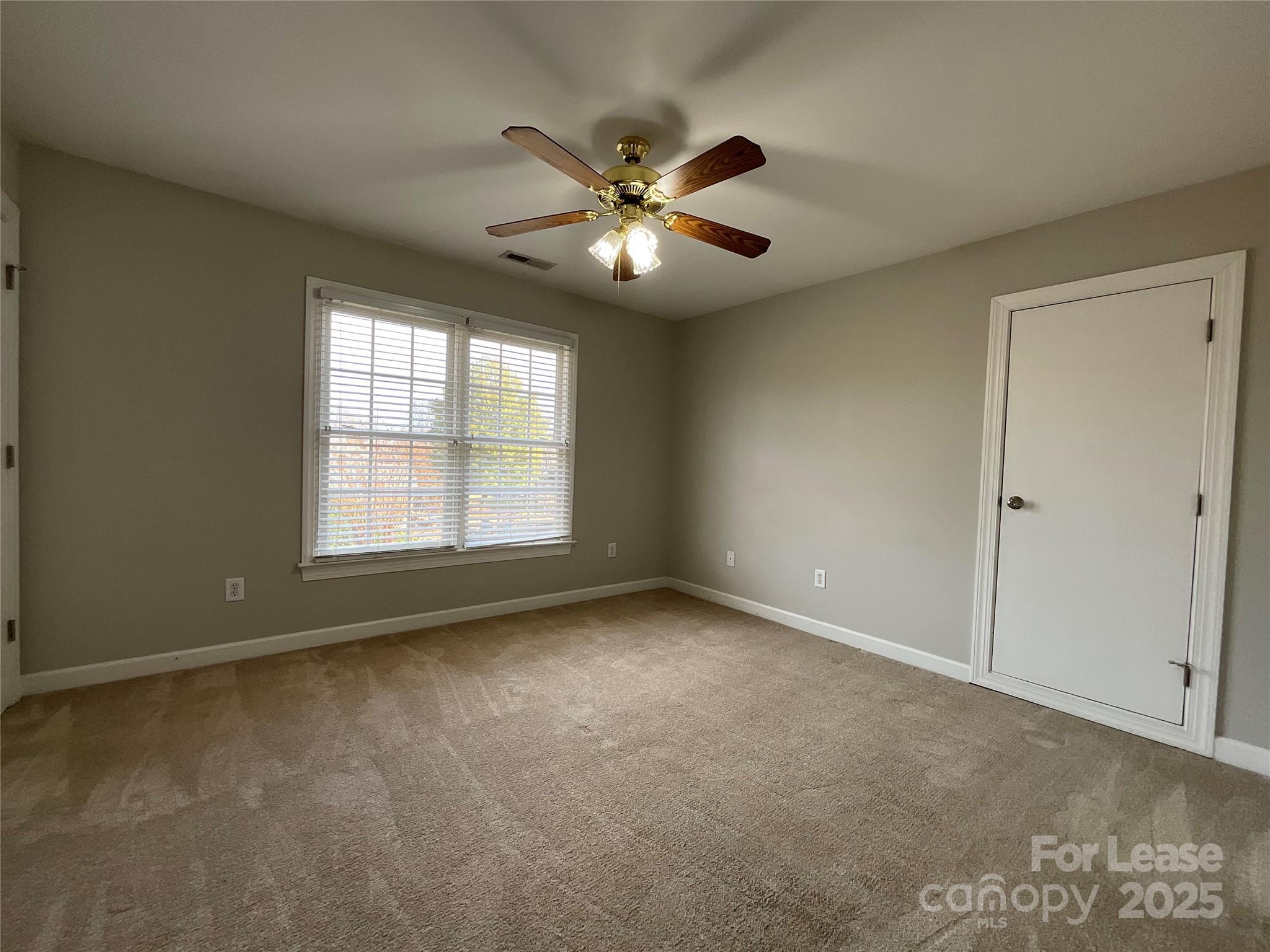 3100 Sea Island Lane Harrisburg, NC 28075 - Photo 23 of 30 a view of an empty room with window and chandelier fan