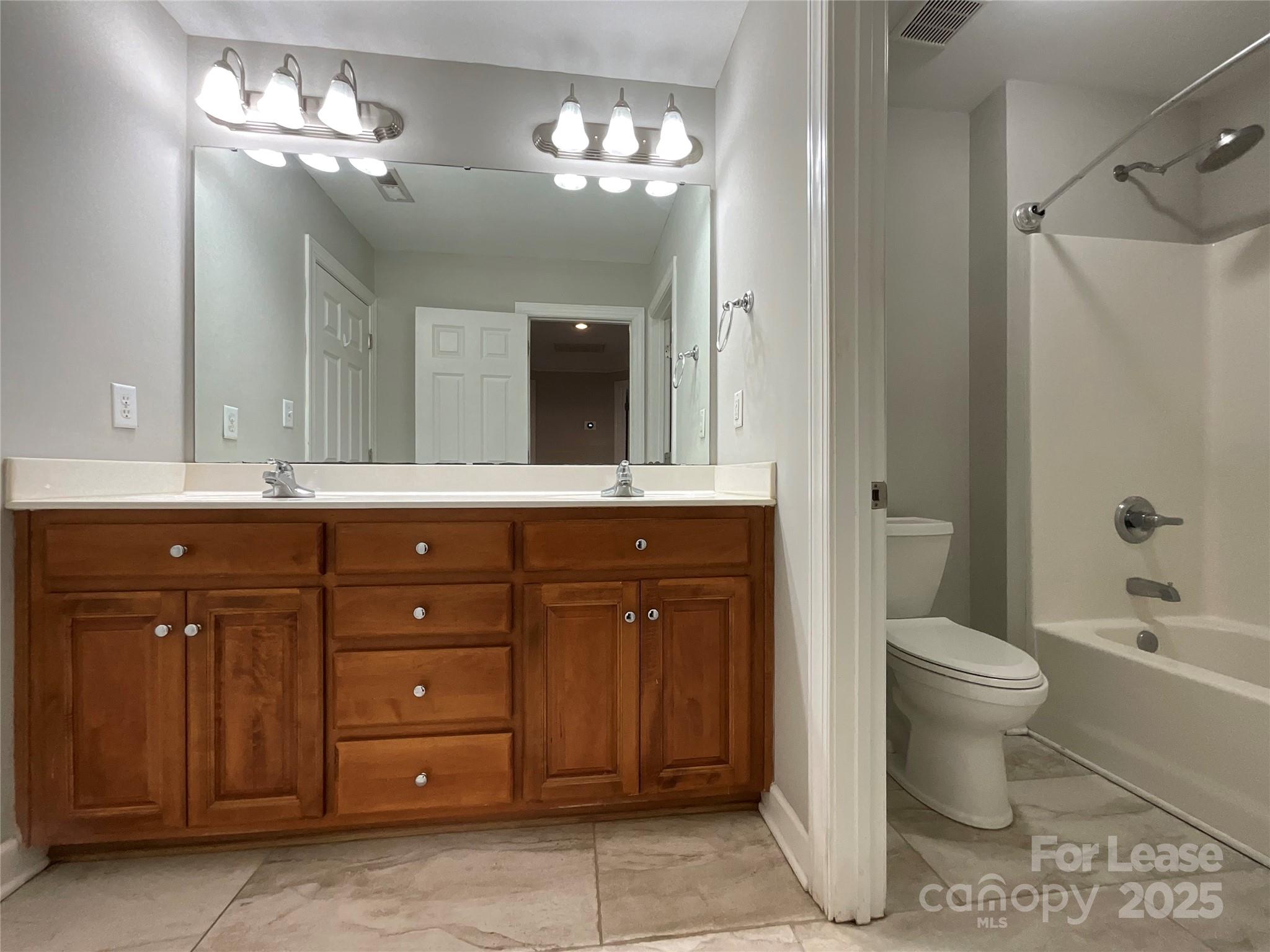 3100 Sea Island Lane Harrisburg, NC 28075 - Photo 25 of 30 a bathroom with a sink vanity granite toilet and a shower