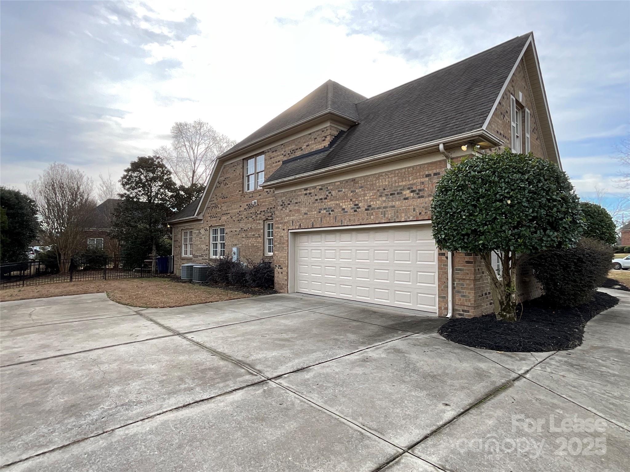 3100 Sea Island Lane Harrisburg, NC 28075 - Photo 26 of 30 a front view of a house with a yard and garage