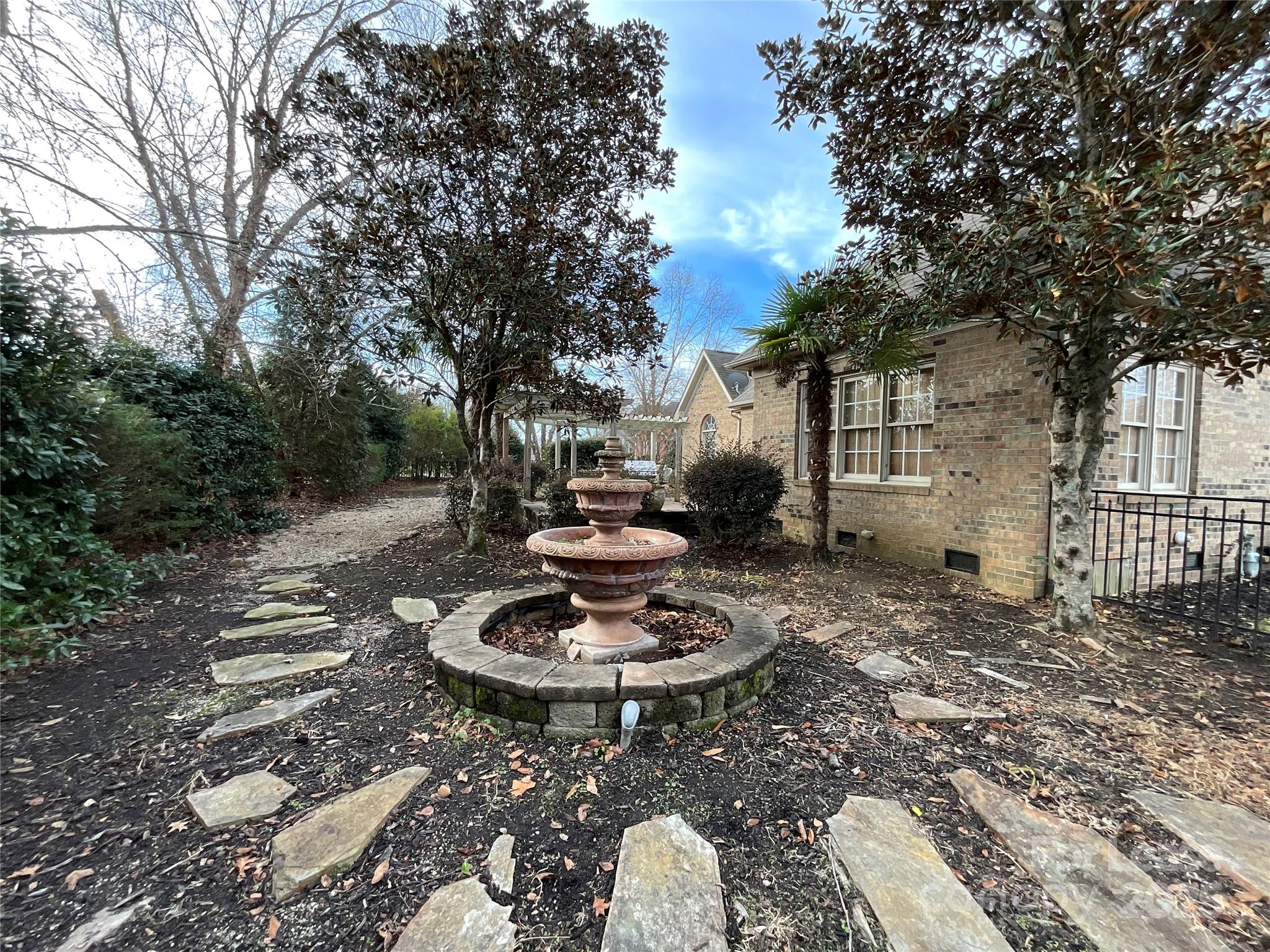 3100 Sea Island Lane Harrisburg, NC 28075 - Photo 30 of 30 a backyard of a house with a fire pit and outdoor seating
