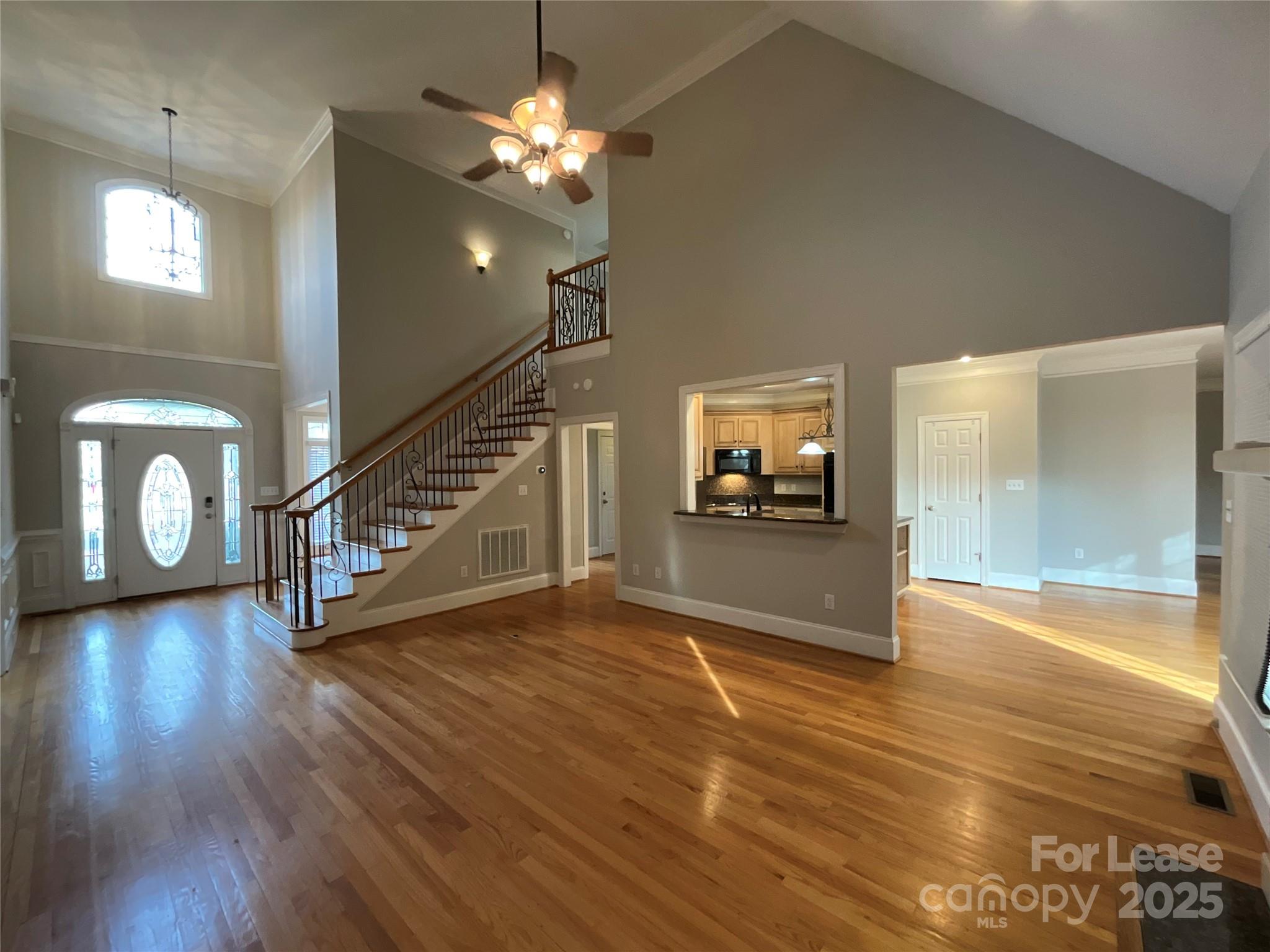 3100 Sea Island Lane Harrisburg, NC 28075 - Photo 6 of 30 a view of a hallway with wooden floor and staircase