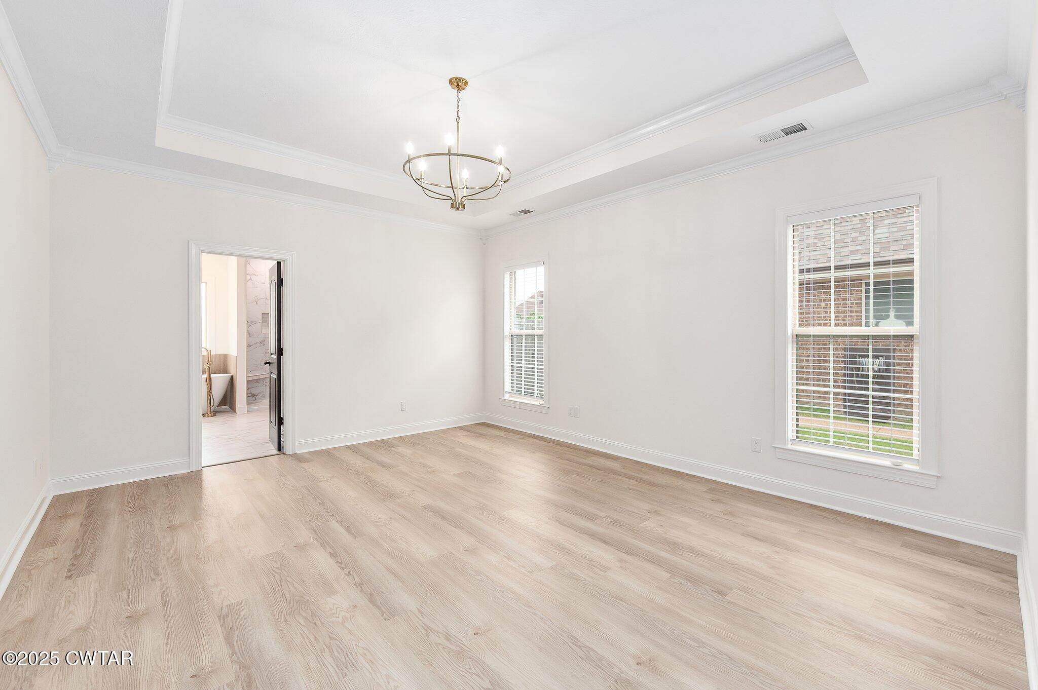 24 Joseph Cove Jackson, TN 38305 - Photo 11 of 37 an empty room with wooden floor and windows