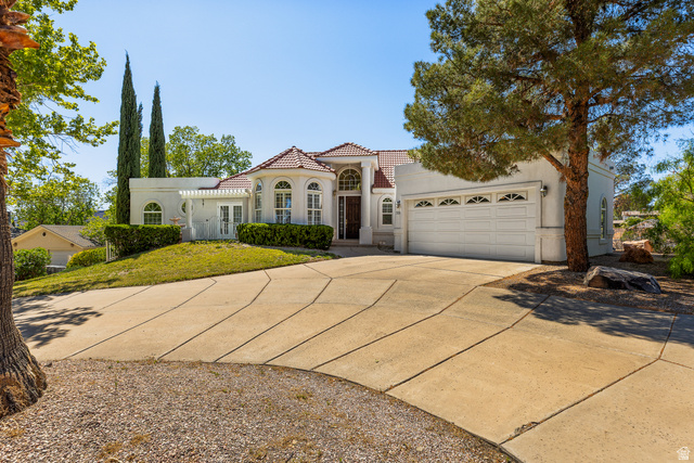 389 North Main Street St. George, UT 84770 - Photo 3 of 44 Mediterranean / spanish home with concrete driveway, stucco siding, an attached garage, and a tile roof