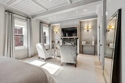 a living room with furniture a flat screen tv and a large window